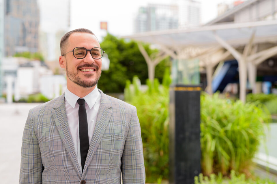 Happy Hispanic bald bearded businessman with eyeglasses thinking in the city outdoors - 薄毛カット専門理容室(床屋)・美容室ポータル|USUGE BEAUTY